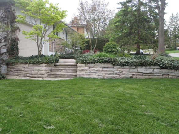 Hand-hewn stone retaining wall. A hard landscaping project.