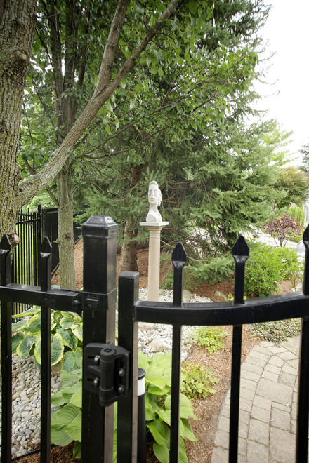 Garden art. Stone sculpture in its backyard setting. Daphne & Apollo. Limestone.