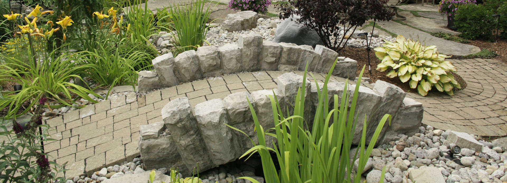 Stone bridge, stone wall, and garden sculpture project in London Ontario