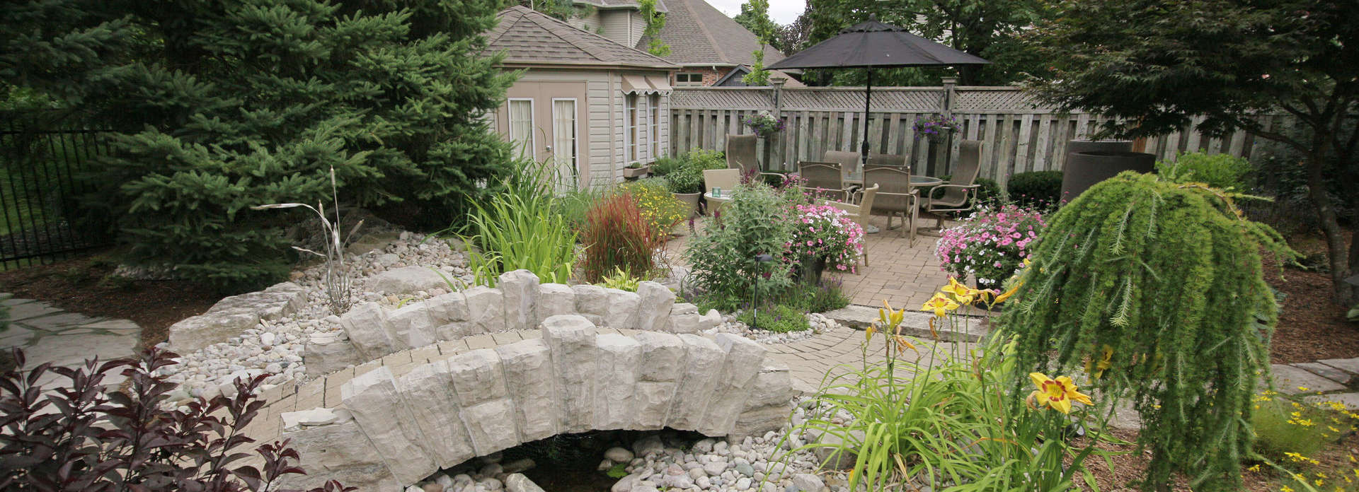 Stone bridge, stone wall, and garden sculpture project in London Ontario