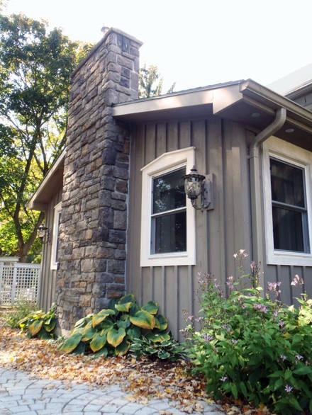 Hend-hewn stone chimney. A stone masonry project.