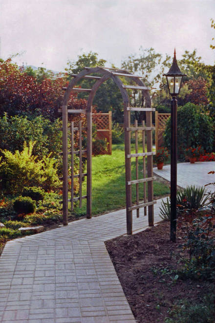 Brick paver. Garden pathway. Trellis.