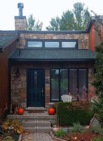 Natural stone thick veneer renovation, walls and chimney. A stone masonry project.